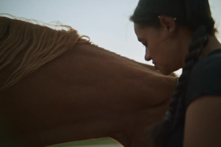 Woman putting a rope on a horse