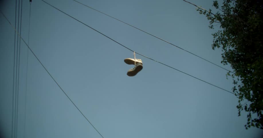 Sneakers hang from the utility wire