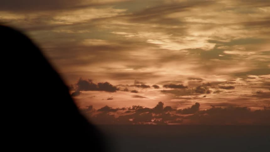 The sun rises lighting up the clouds