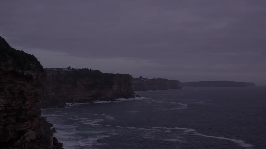 Waves hit the cliffs of the shore