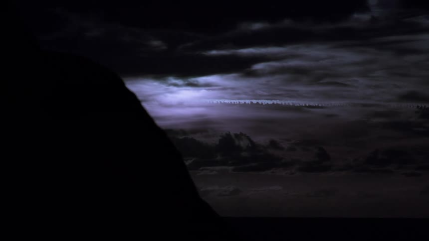 Dark landscape with clouds passing by and the day getting dark
