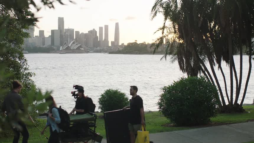 A film crew walks by the city