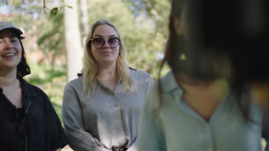 Women look at footage on a camera