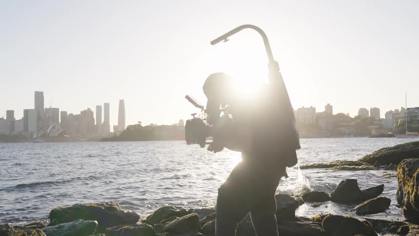 Boy filming at sea