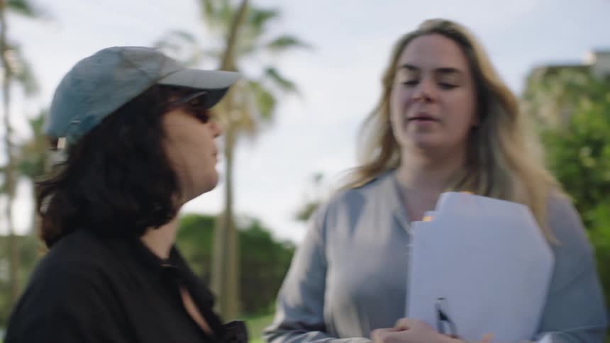 Three women outdoors talking to each other