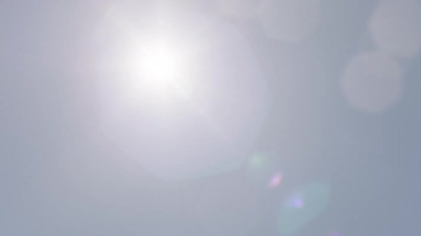 View of the cloudless blue sky with the sun in the spotlight