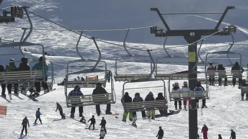 People riding ski lifts