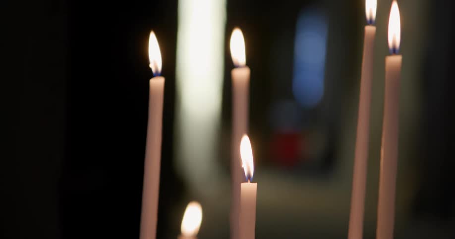 Close up of lit white candles