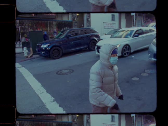 Elderly person crossing the road and moving vehicles in the city