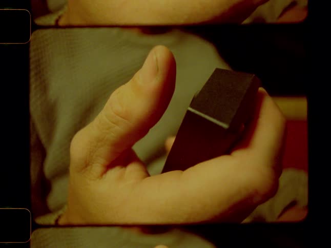 A persons hand using their thumb to click a button on a remote control