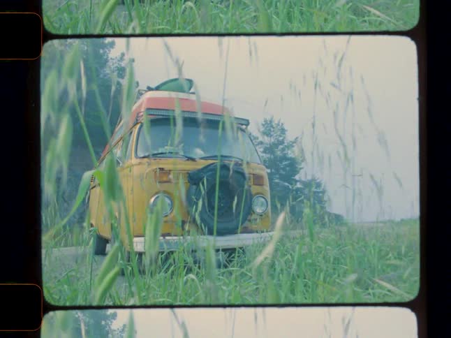 Old yellow van parked on the side of the road