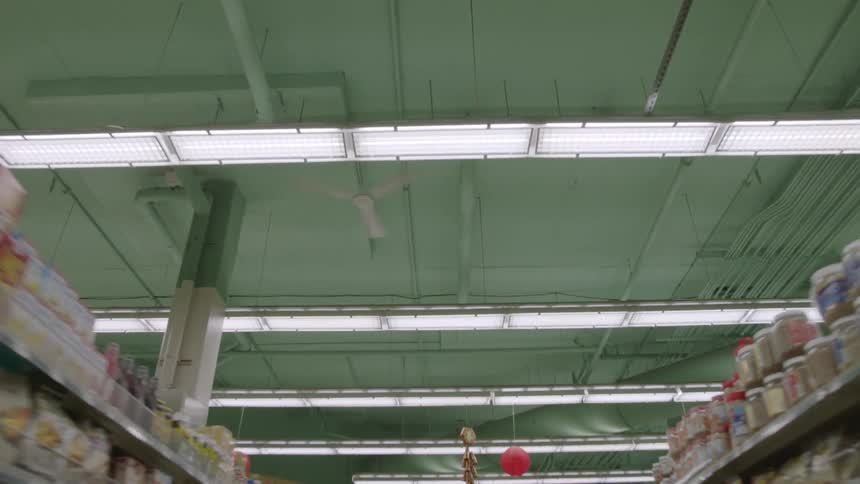 Moving down a grocery aisle and looking up to a ceiling fan