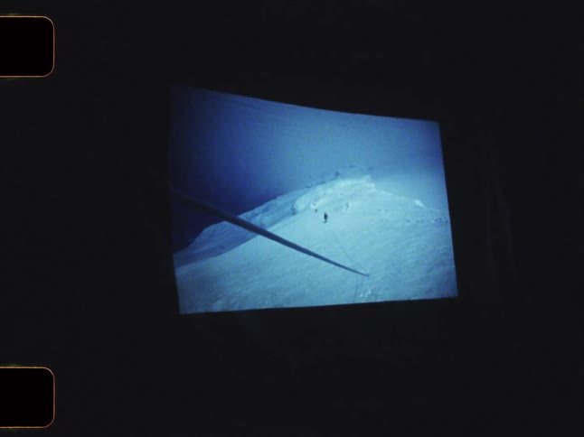 Close up of a screen displaying photos of snowy mountains
