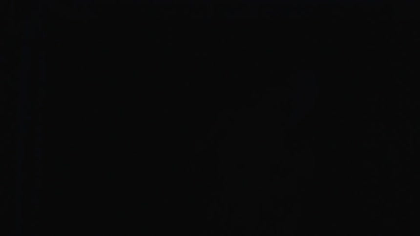 Woman dances in a dark office at night