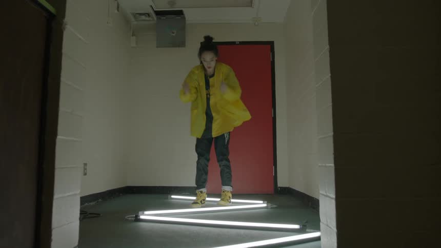 Woman dances in a hallway