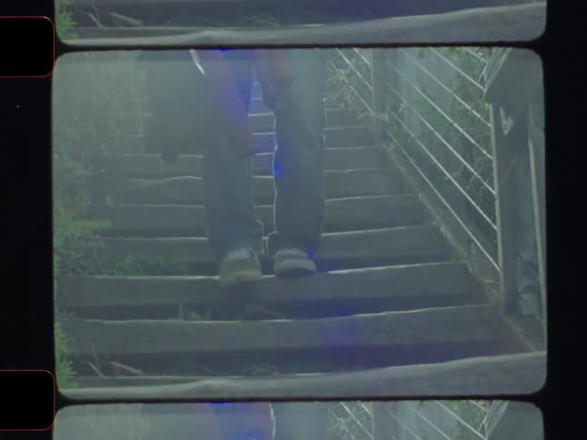 Silhouette of a person walking down stairs in an outdoor setting