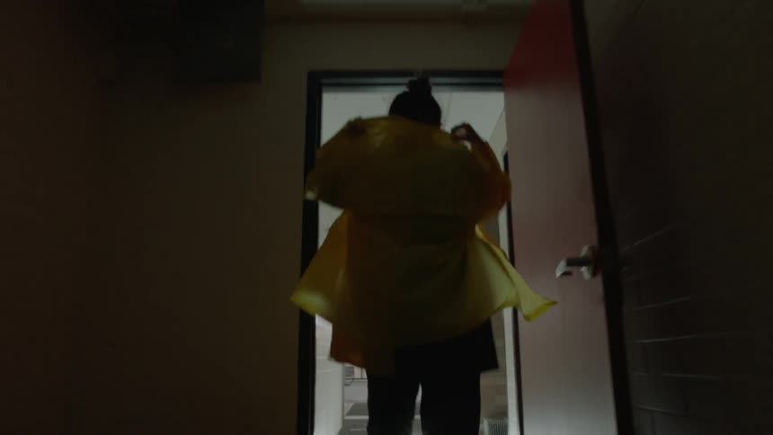 Woman walking down the hallway and into an empty pool