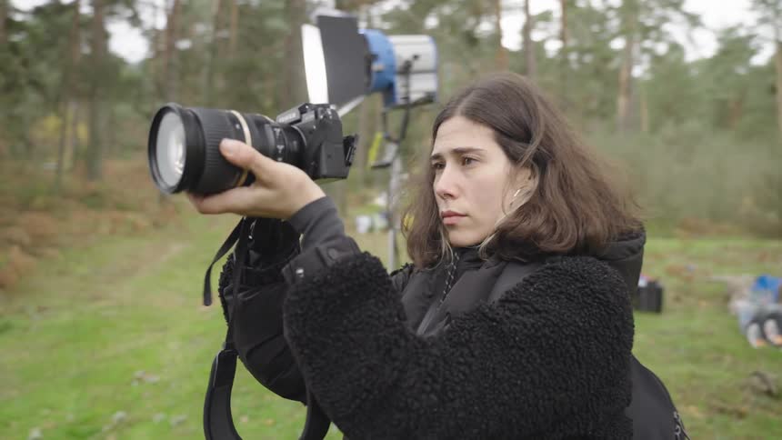 A woman is photographing on the film set