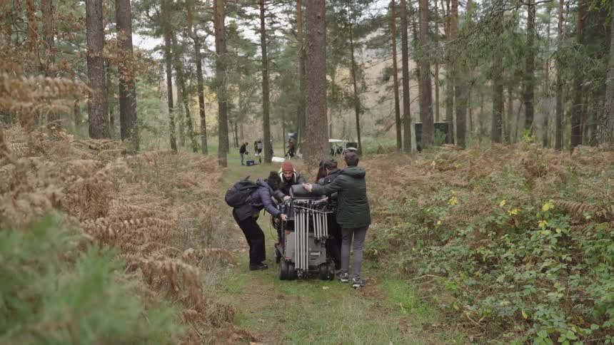 People are rolling equipment into the forest