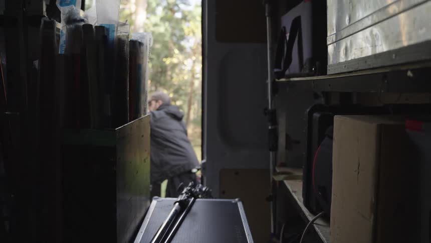 Man closing the back doors of a van with recording equipment
