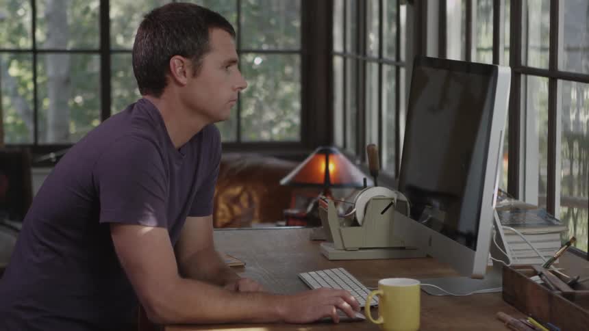 Man works at a computer and then leaves