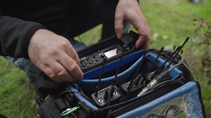 Pair of hands of a person conducting recording devices