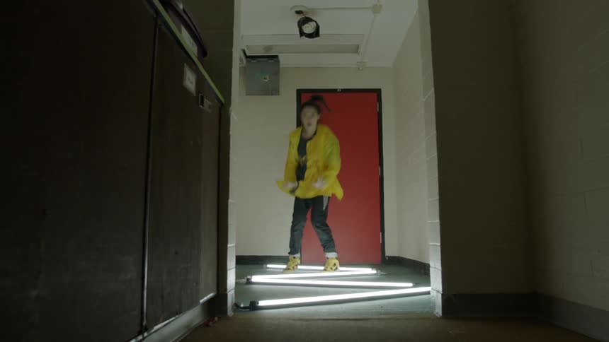 Woman dances in a hallway