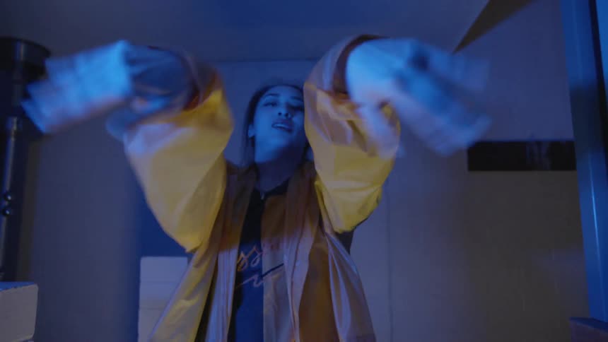 Woman dances in a dark office at night