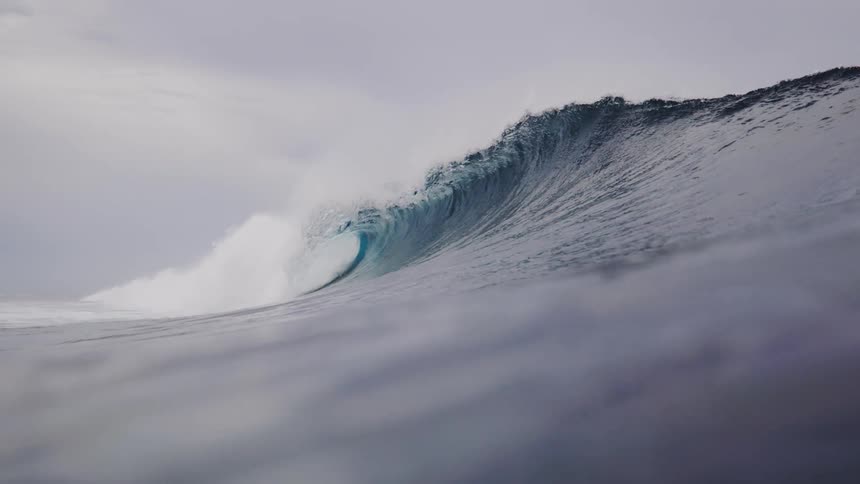 A large wave moves across the ocean