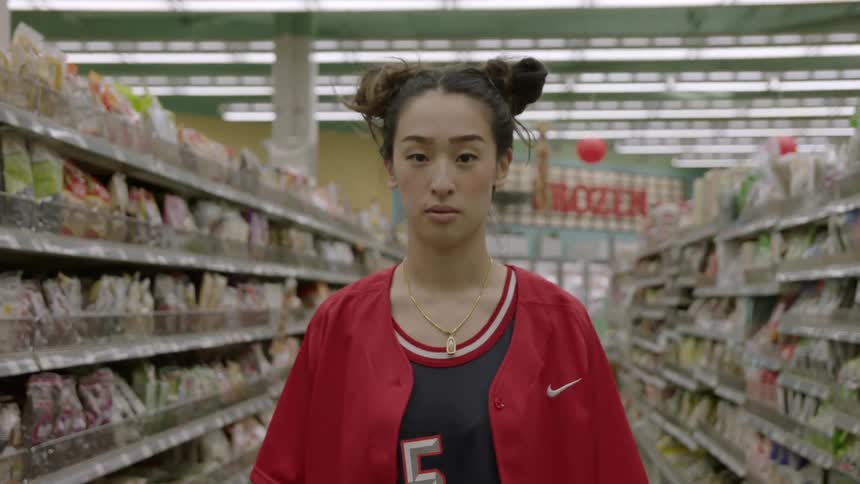 Woman stands in an aisle in a grocery store