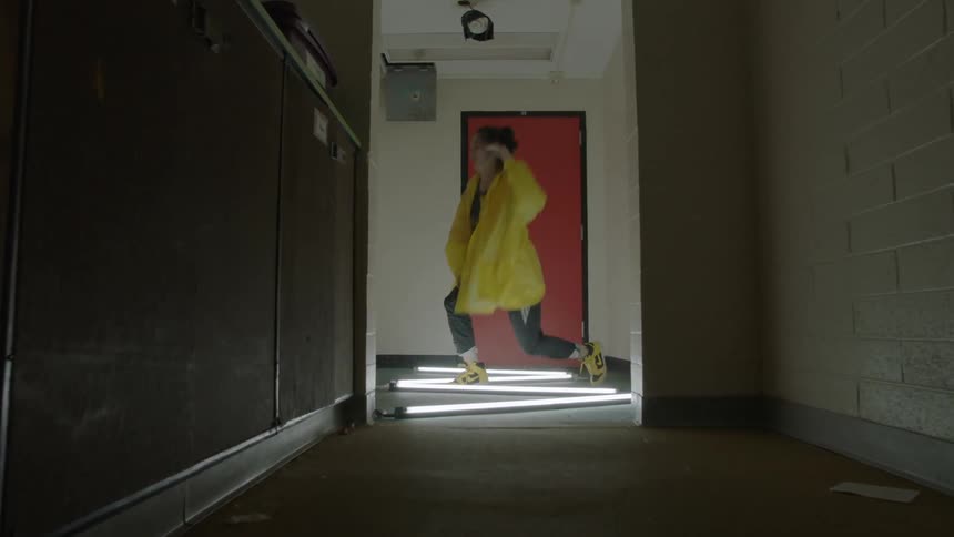 Woman dancing in the hallway of an office building