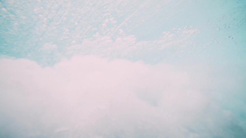 Underwater view of the ocean below a breaking tubular wave