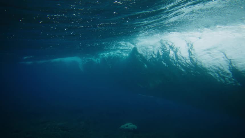 Bottom view of the ocean with a wave breaking
