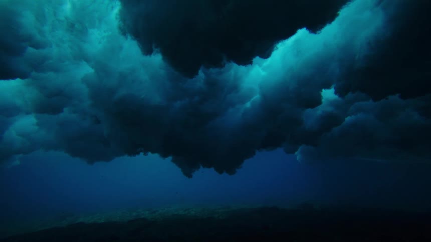 The wave crashes along the ocean floor underwater