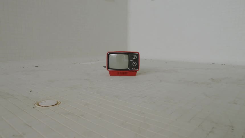 Tv on the floor in a white room