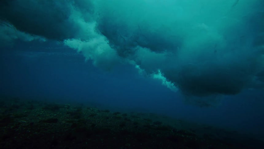 The wave crashes and the clouds go all the way to the sea floor
