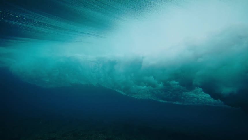 Underwater view of a tubular wave passing close to corals
