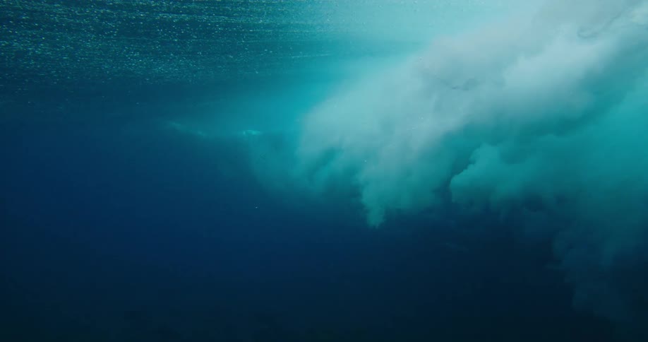 View from below of the ocean waters and a strong wave passing by