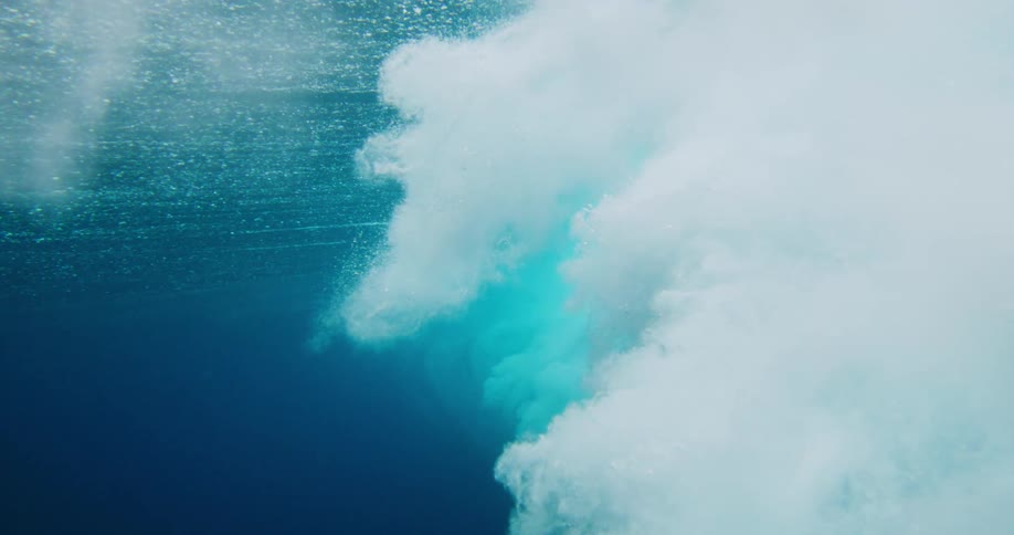 Underwater view with a tubular wave of foam and force passing by