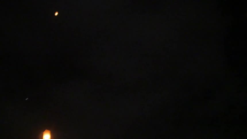 Lanterns float in the night sky