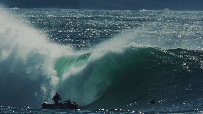 A wave crashes on the person filming on the jet ski