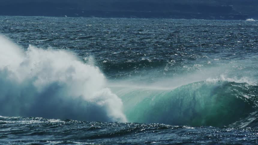 The wave moves and sprays water around