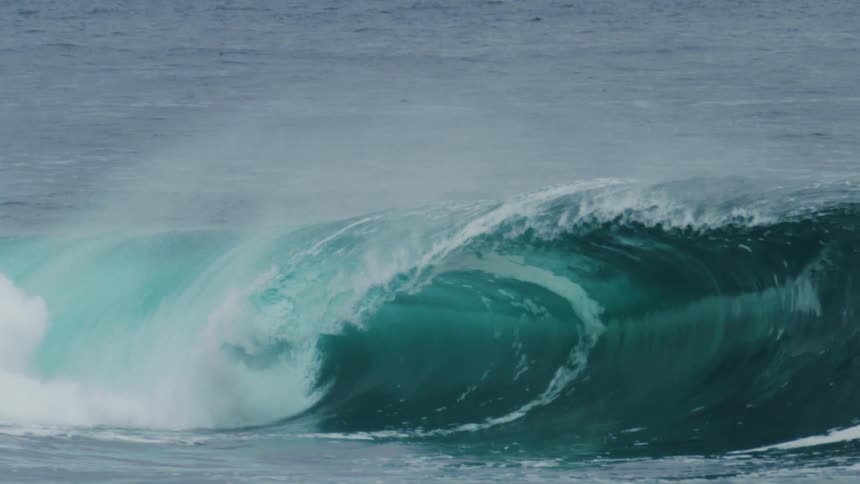 Turquoise blue tubular wave breaking in the ocean