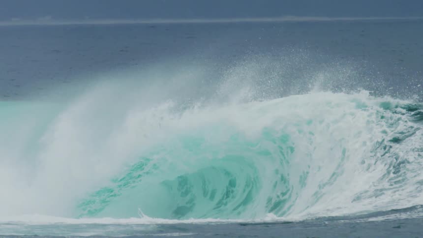 Strong tubular wave with foam breaking in the ocean