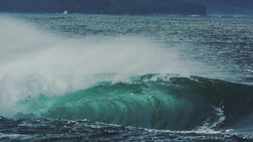 Turquoise blue tubular wave breaking in the ocean