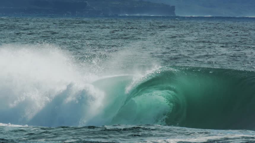 Turquoise blue wave breaking strongly in the ocean