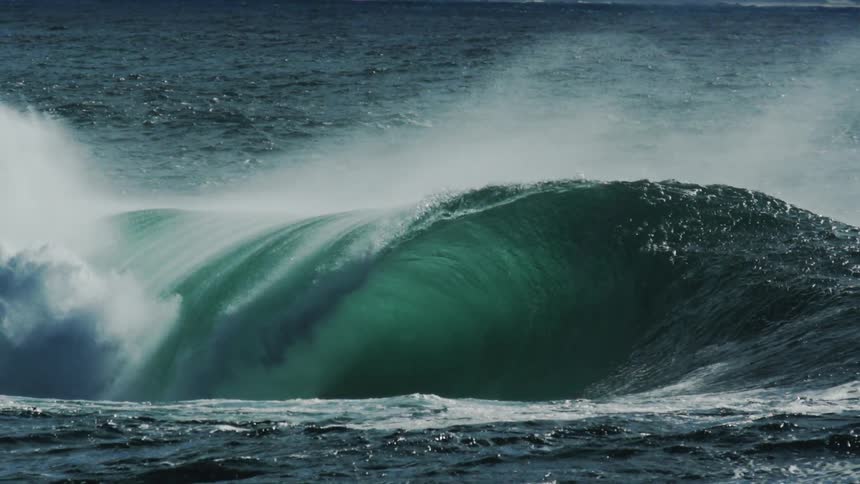 A large wave forms a perfect barrel as it rolls over