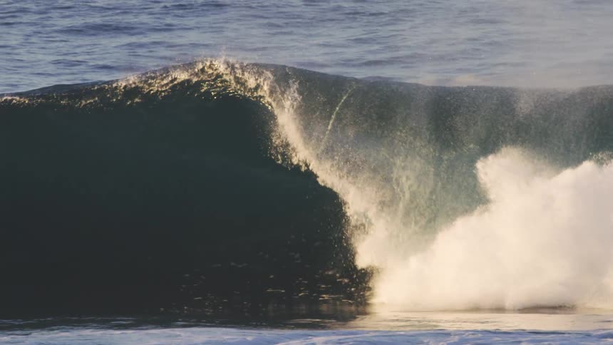Surfers riding a tubular wave in the ocean