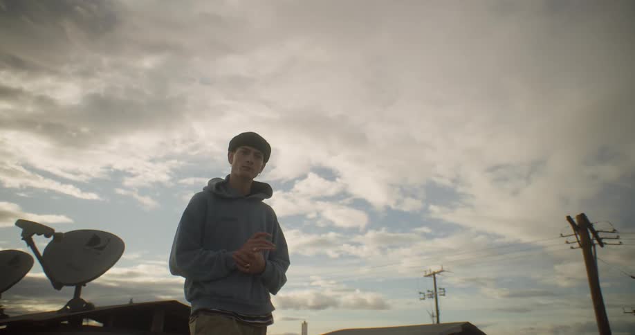 A teenager walks by the homes