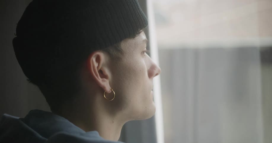 Side portrait of a thoughtful man looking out the window